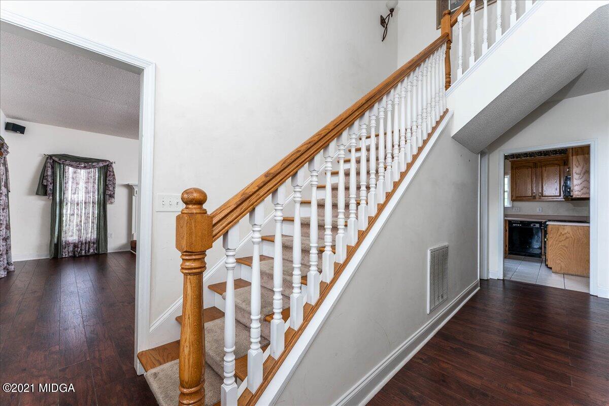 7455 Columbus Road Lizella, GA 31052 - Photo 24 of 32 a view of an entryway with wooden floor and stairs