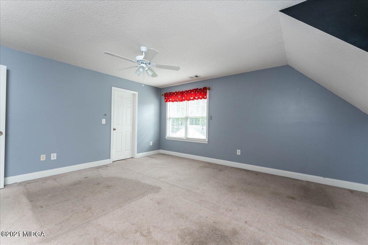 7455 Columbus Road Lizella, GA 31052 - Photo 28 of 32 an empty room with windows and fan