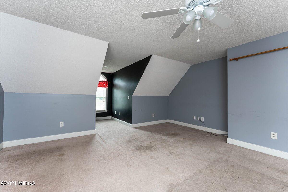 7455 Columbus Road Lizella, GA 31052 - Photo 29 of 32 an empty room with fan and windows