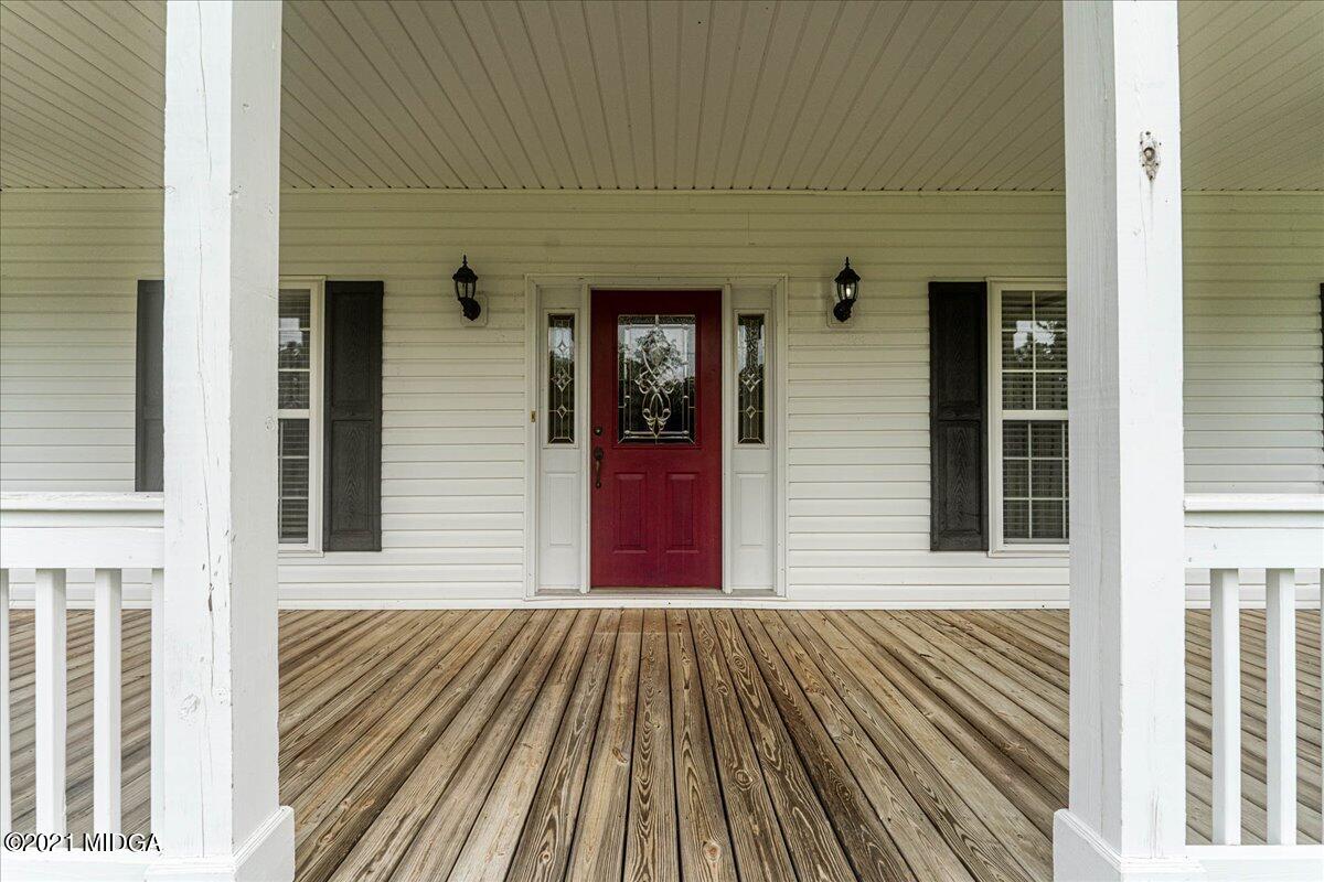 7455 Columbus Road Lizella, GA 31052 - Photo 4 of 32 a view of a brick house with large windows