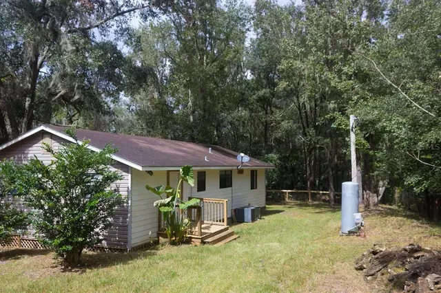 a view of a house with backyard porch and sitting area