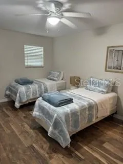 a bedroom with two beds and a chandelier