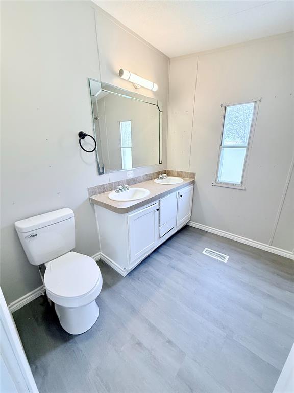 6100 Preston Road Denison, TX 75020 - Photo 11 of 20 a bathroom with a toilet sink and mirror