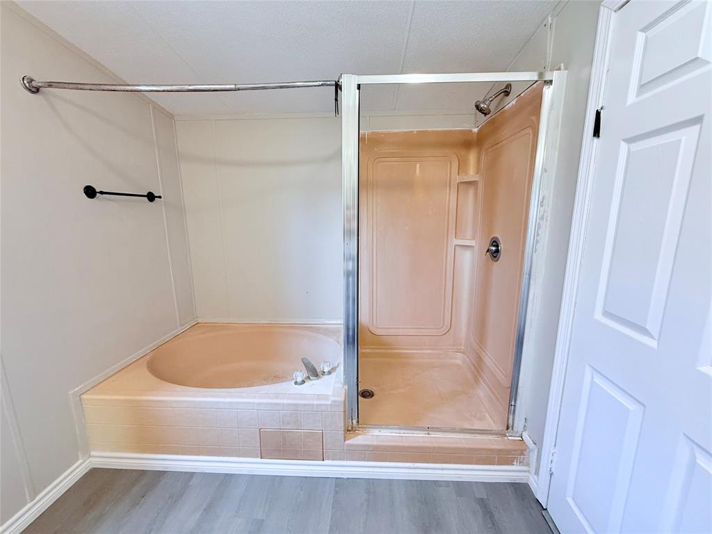 6100 Preston Road Denison, TX 75020 - Photo 12 of 20 a bathroom with a tub and shower