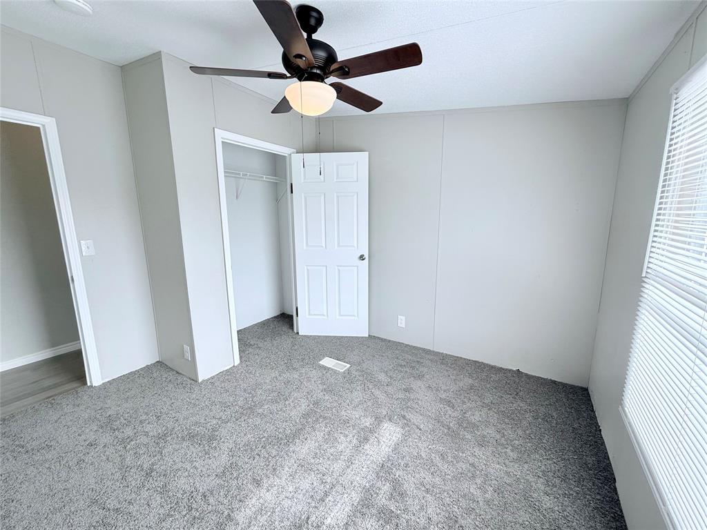 6100 Preston Road Denison, TX 75020 - Photo 13 of 20 an empty room with a window and a fan
