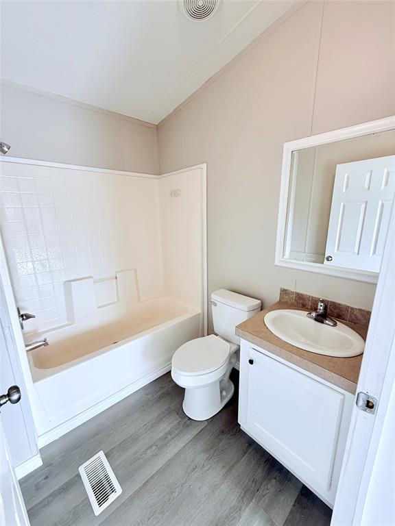 6100 Preston Road Denison, TX 75020 - Photo 14 of 20 a bathroom with a sink toilet and shower