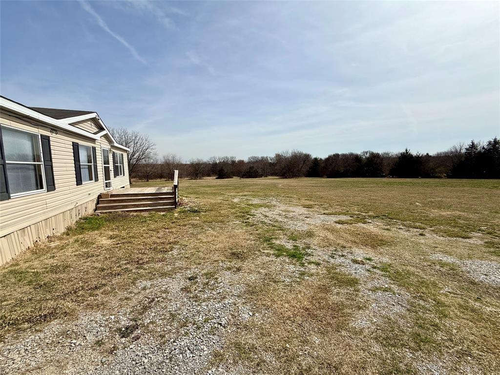 6100 Preston Road Denison, TX 75020 - Photo 16 of 20 a front view of a house with a yard