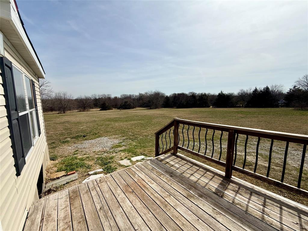 6100 Preston Road Denison, TX 75020 - Photo 17 of 20 a view of balcony with wooden floor and fence
