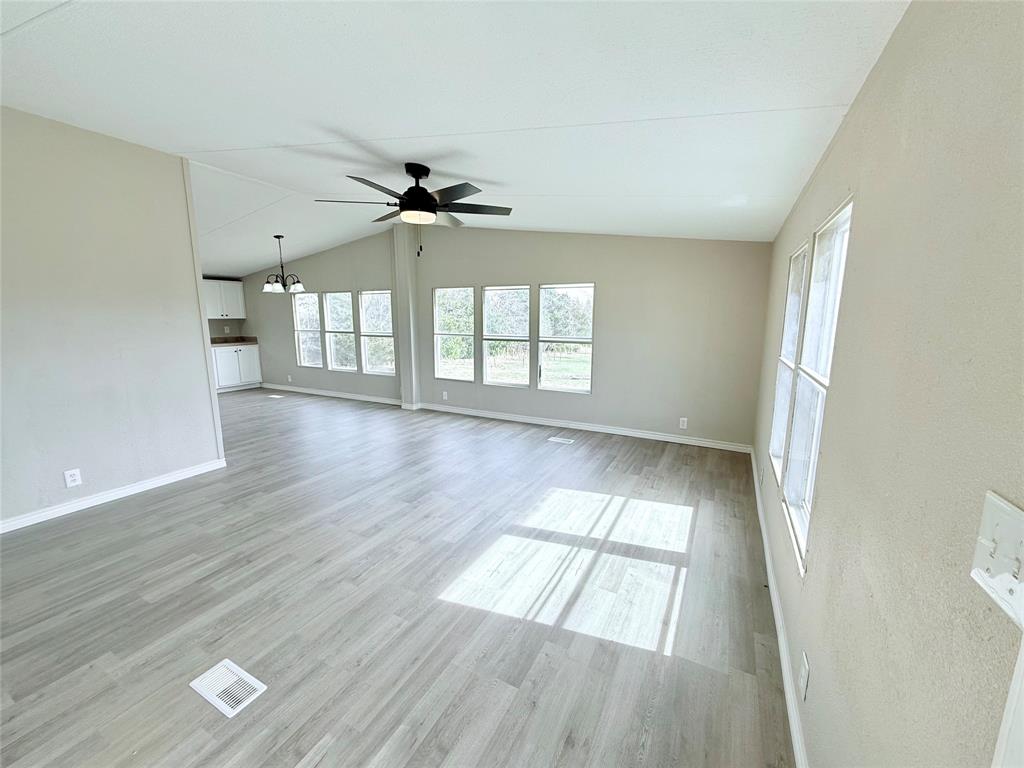 6100 Preston Road Denison, TX 75020 - Photo 2 of 20 an empty room with wooden floor and windows