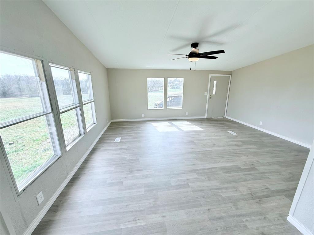 6100 Preston Road Denison, TX 75020 - Photo 3 of 20 wooden floor in an empty room with a window