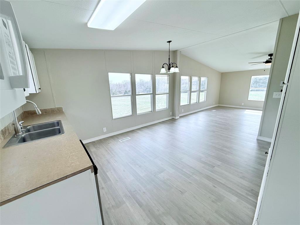 6100 Preston Road Denison, TX 75020 - Photo 6 of 20 a view of a room with wooden floor and chandelier