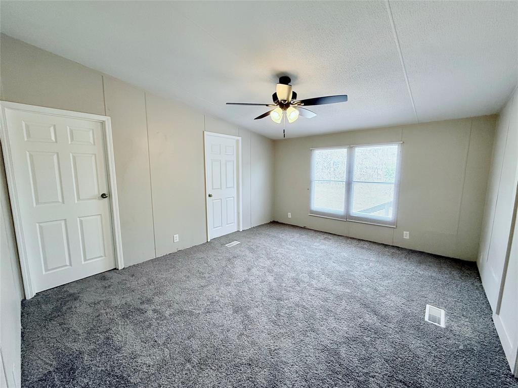 6100 Preston Road Denison, TX 75020 - Photo 8 of 20 an empty room with windows and ceiling fan