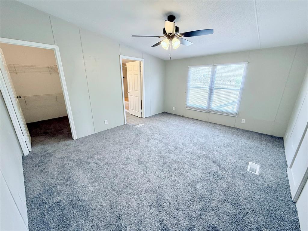 6100 Preston Road Denison, TX 75020 - Photo 9 of 20 an empty room with windows and cabinet