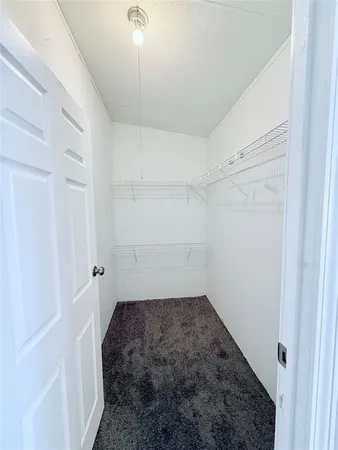 a room with a white bed and a shower