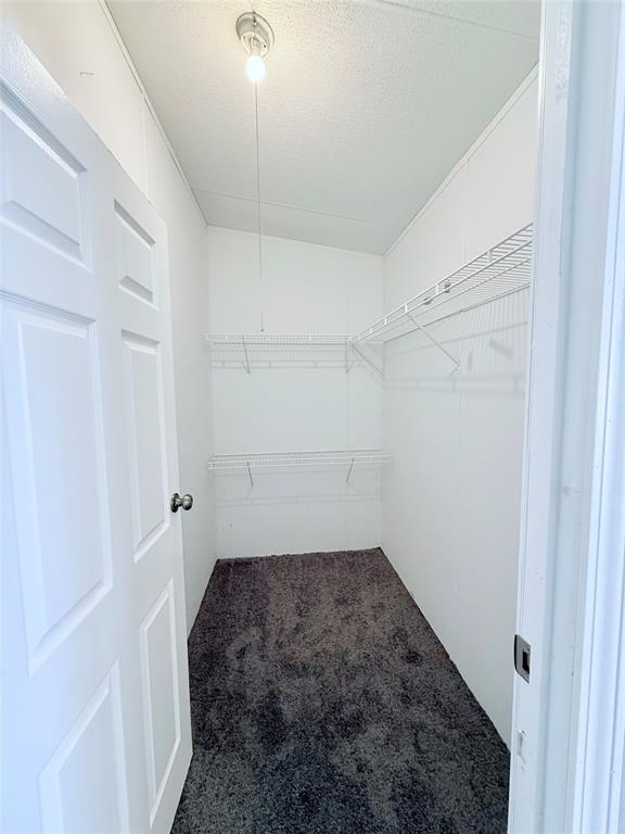 6100 Preston Road Denison, TX 75020 - Photo 10 of 20 a room with a white bed and a shower
