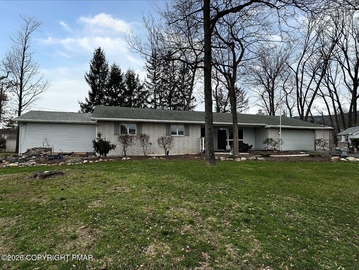 1055 Pine Tree Drive Slatington, PA 18080 - Photo 1 of 38 a front view of house with yard and seating area
