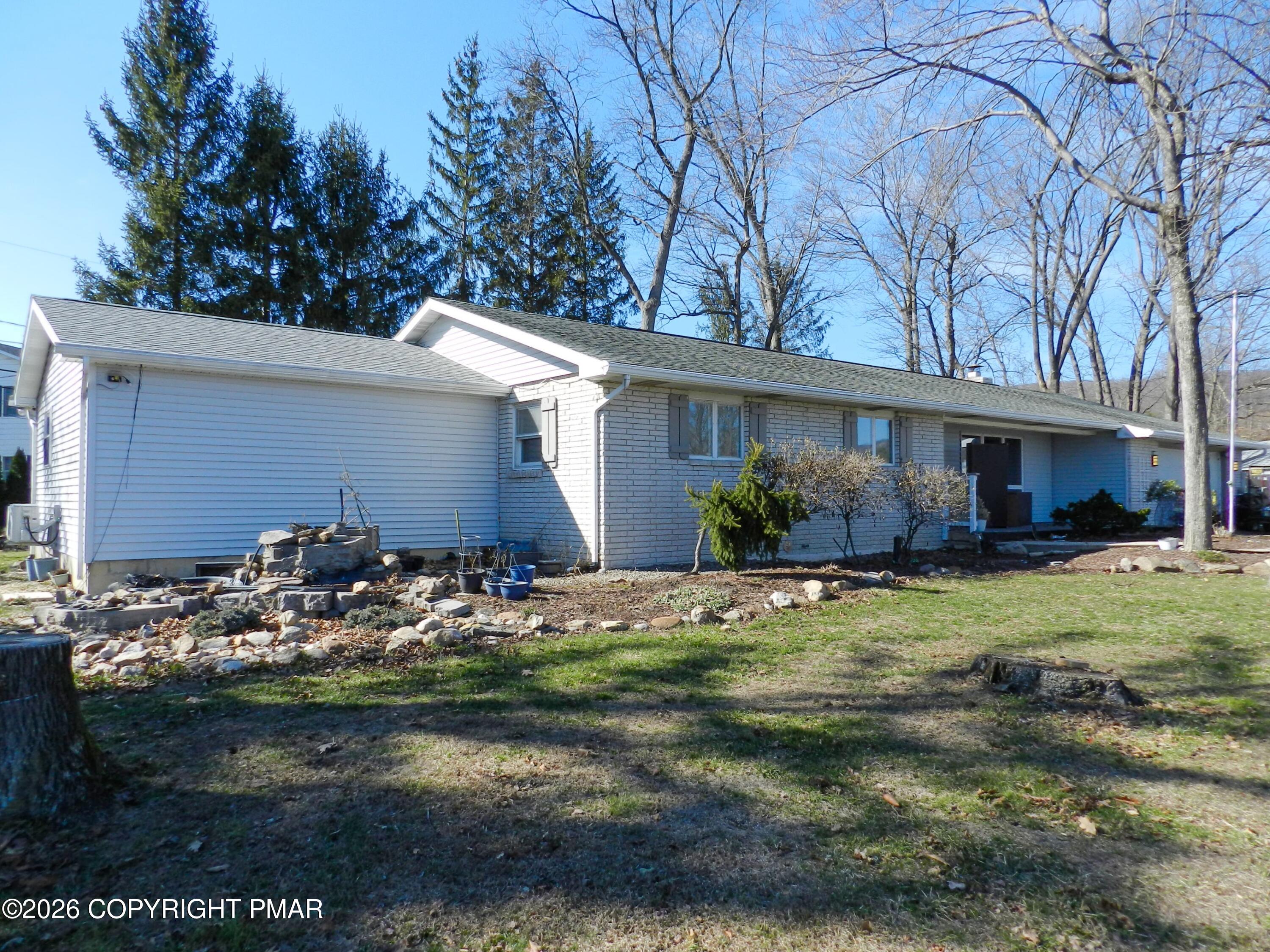 1055 Pine Tree Drive Slatington, PA 18080 - Photo 3 of 38 a front view of a house with garden