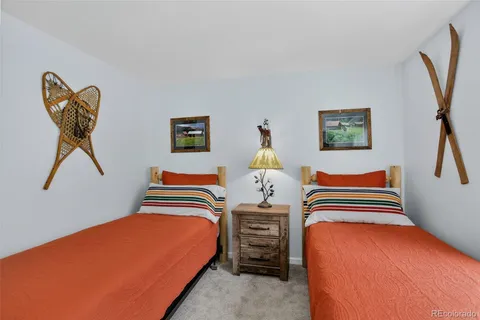 a bedroom with a bed and a painting on the wall