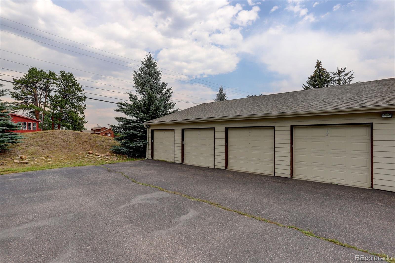 29656 Buffalo Park Road, Unit 209 Evergreen, CO 80439 - Photo 18 of 22 a view of a house with a garage