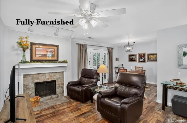 a living room with furniture and a fireplace