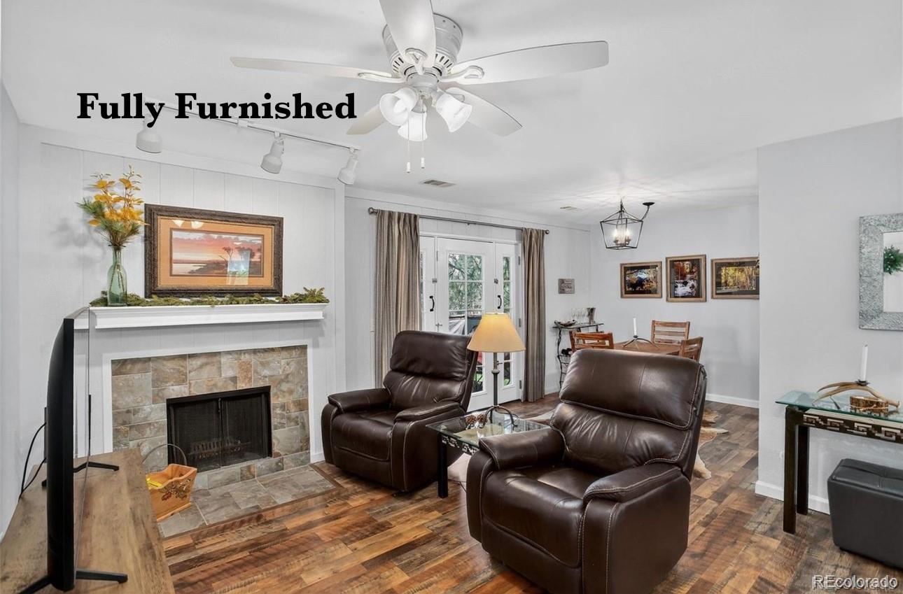 29656 Buffalo Park Road, Unit 209 Evergreen, CO 80439 - Photo 2 of 22 a living room with furniture and a fireplace