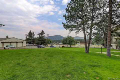 a view of an house with backyard space and balcony