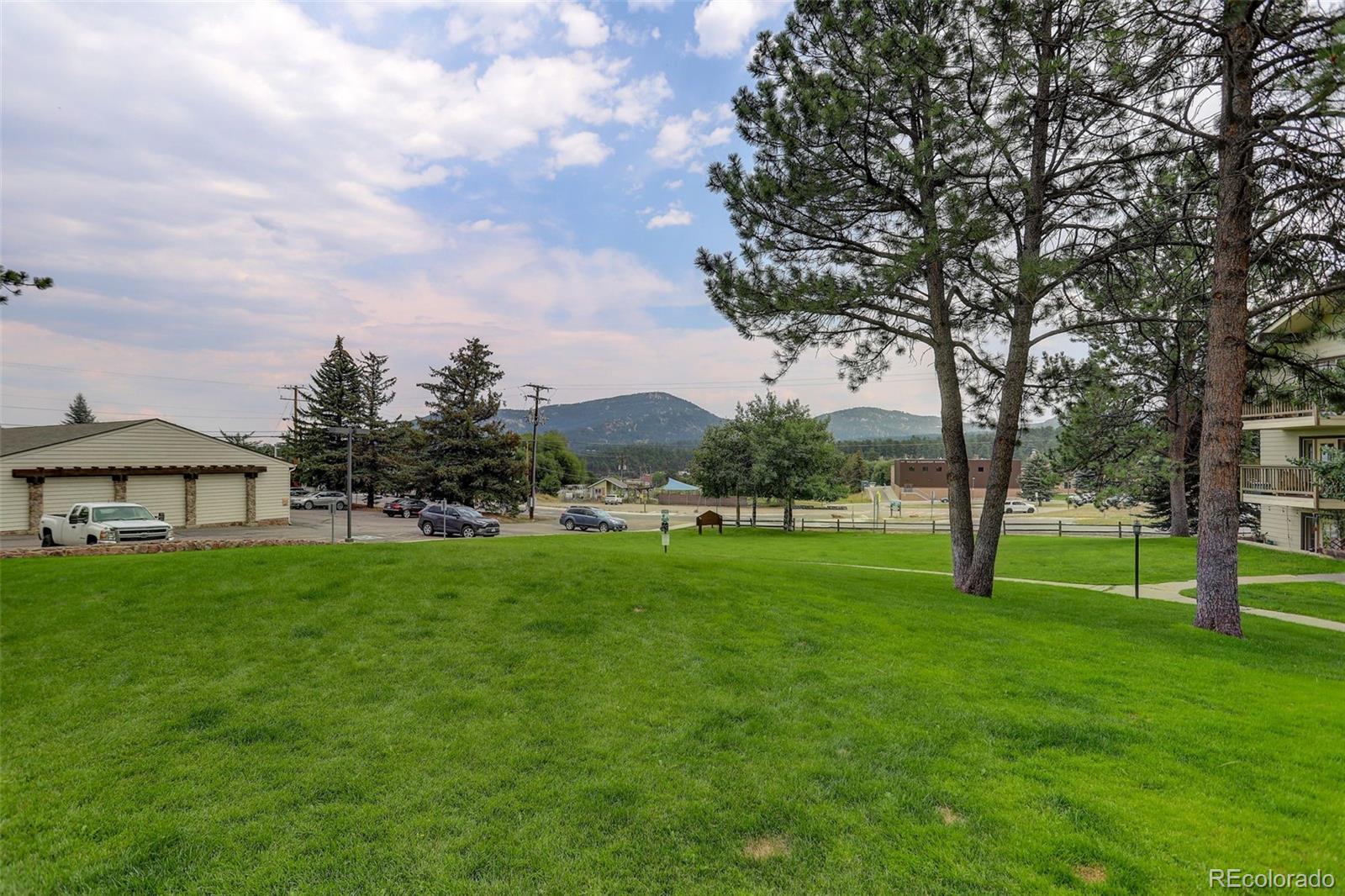 29656 Buffalo Park Road, Unit 209 Evergreen, CO 80439 - Photo 21 of 22 a view of an house with backyard space and balcony