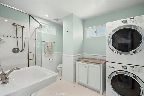 a bathroom with a sink a washer and dryer