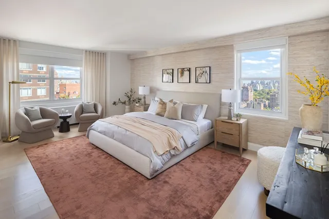 a spacious bedroom with a bed a couch and a potted plant on the dresser