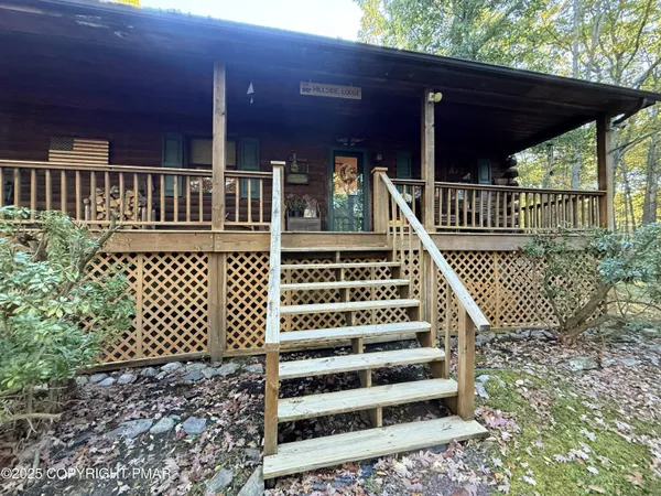 a view of a house with wooden deck