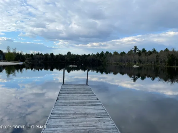 an aerial view of a house with a garden and trees