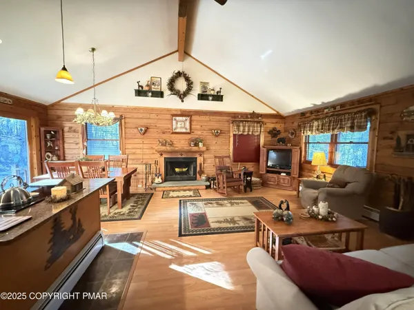 a living room with furniture a fireplace and a view of living room