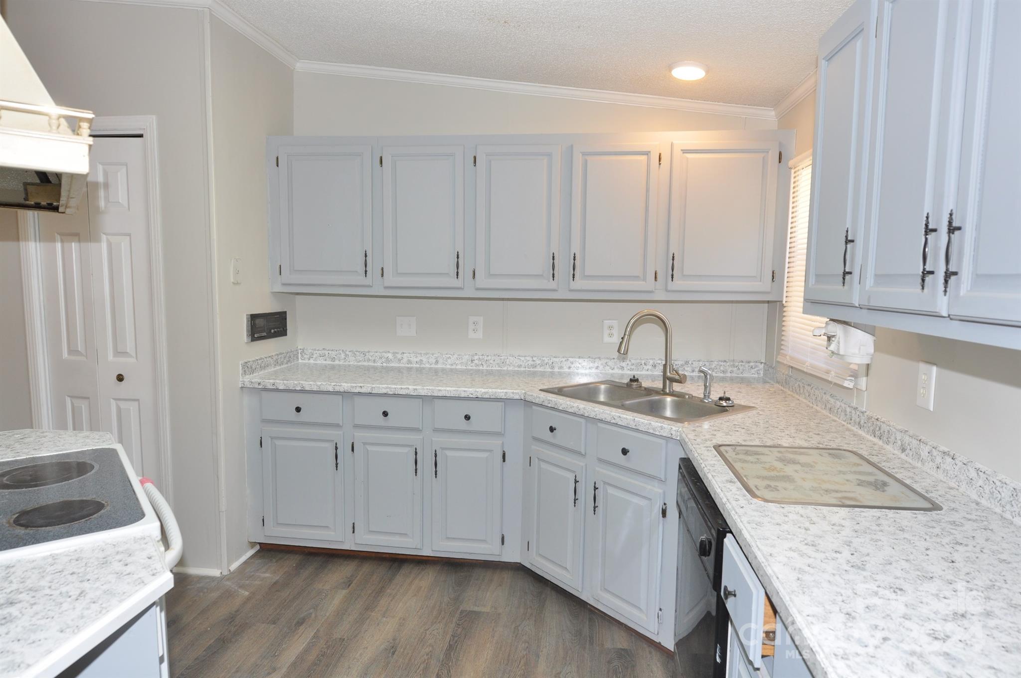 1646 Madison Road, Unit 22 Chester, SC 29706 - Photo 3 of 24 a kitchen with granite countertop white cabinets and sink