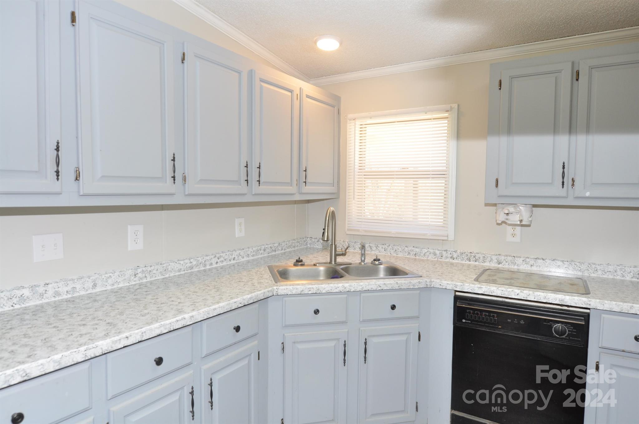 1646 Madison Road, Unit 22 Chester, SC 29706 - Photo 6 of 24 a kitchen with stainless steel appliances white cabinets and a sink
