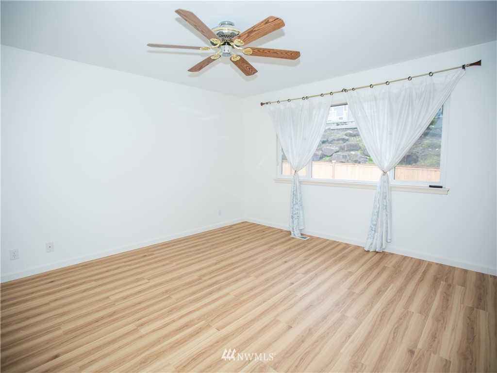 20405 28th Avenue Southeast Bothell, WA 98021 - Photo 8 of 9 a view of empty room with wooden floor and fan