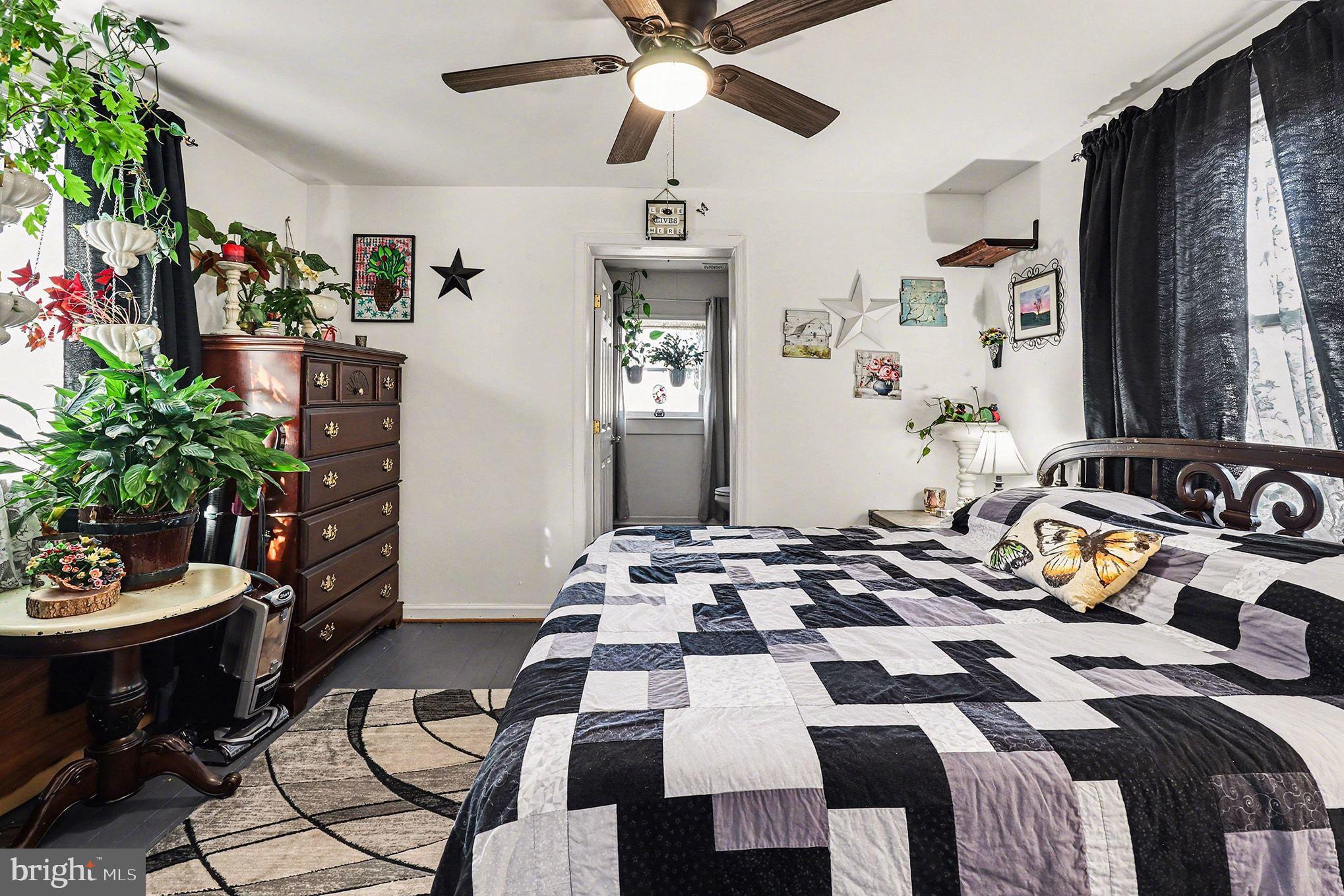 2033 Courthouse Road Heathsville, VA 22473 - Photo 17 of 50 a bedroom with a bed and a chandelier
