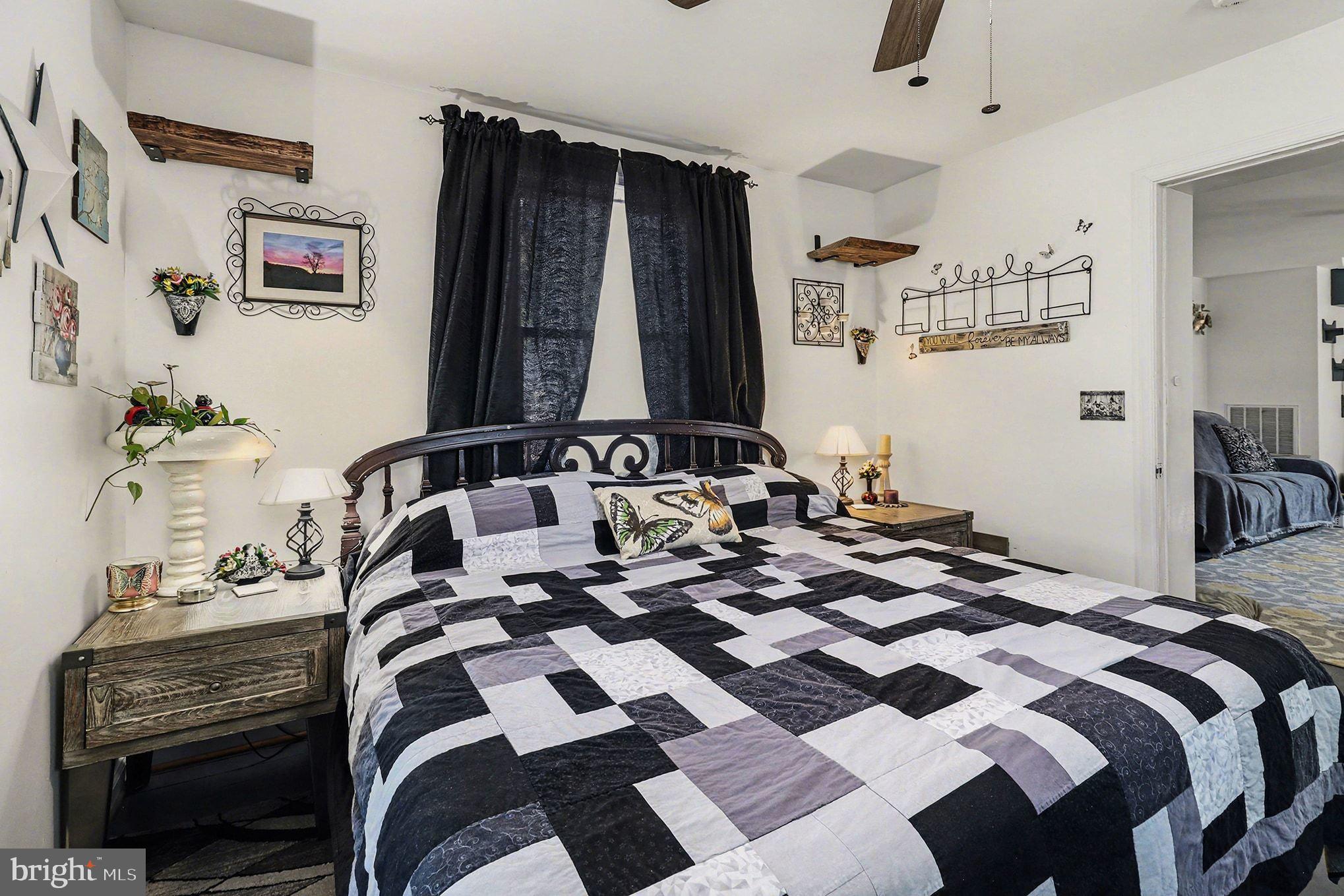 2033 Courthouse Road Heathsville, VA 22473 - Photo 18 of 50 a bedroom with a bed and a lamp