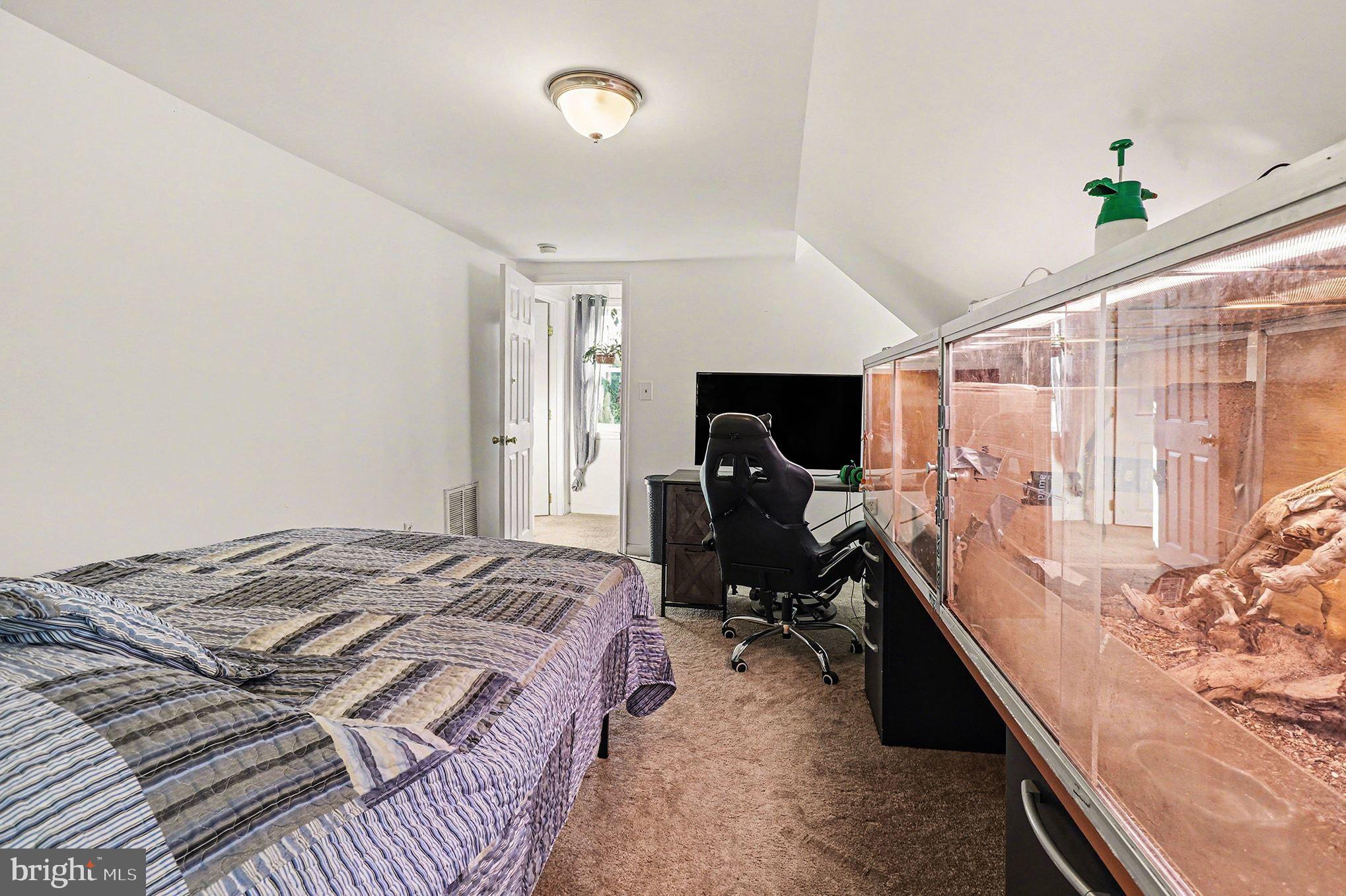 2033 Courthouse Road Heathsville, VA 22473 - Photo 22 of 50 a bed room with a bed window and a flat screen tv