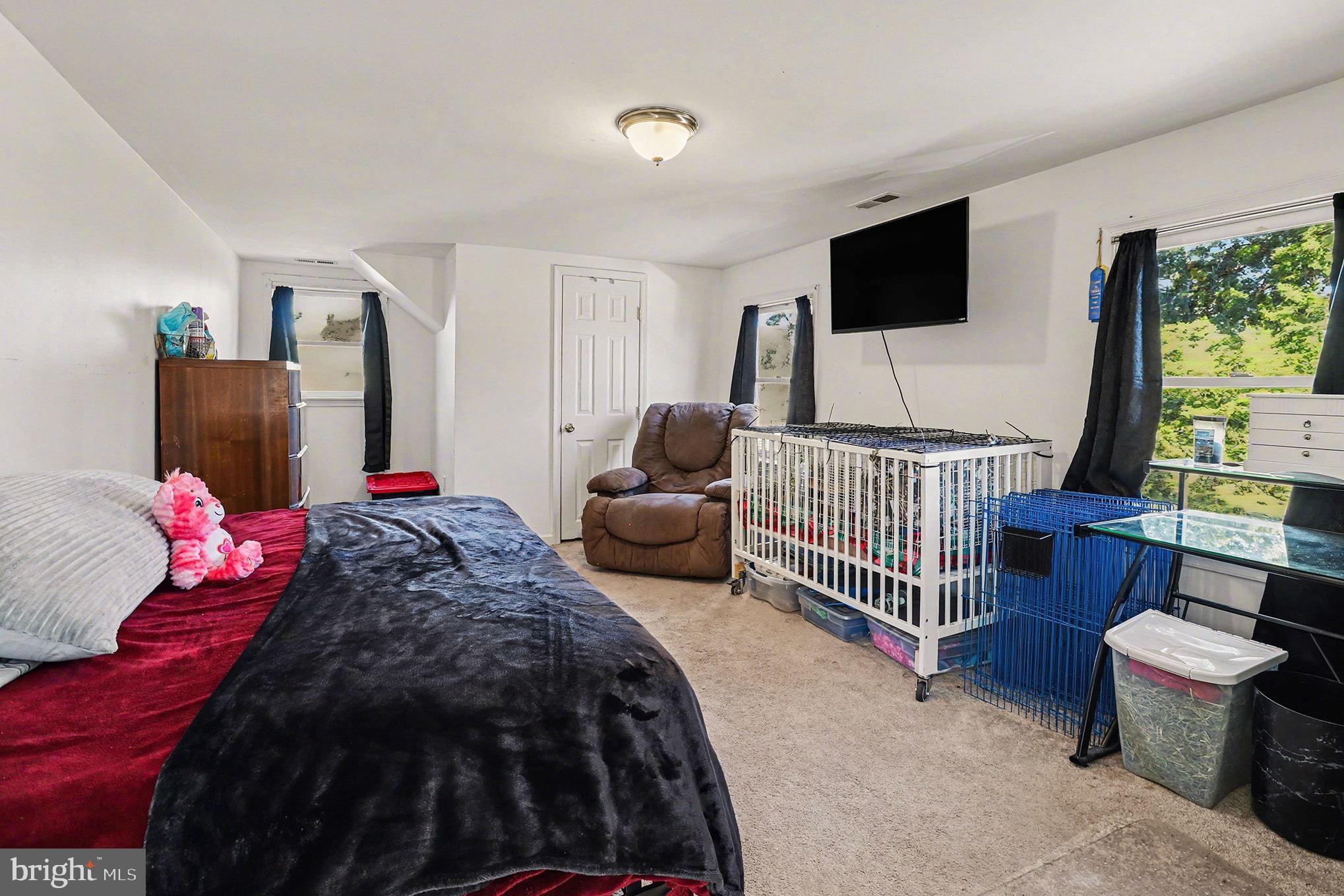 2033 Courthouse Road Heathsville, VA 22473 - Photo 23 of 50 a bedroom with furniture and a flat screen tv