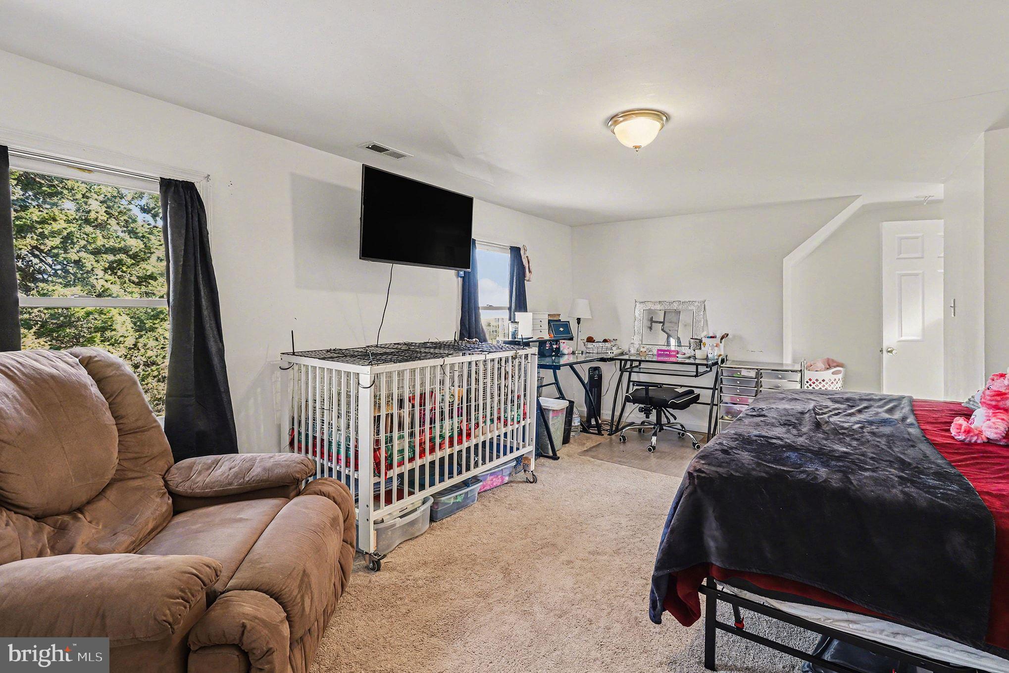 2033 Courthouse Road Heathsville, VA 22473 - Photo 24 of 50 a living room with furniture and a flat screen tv