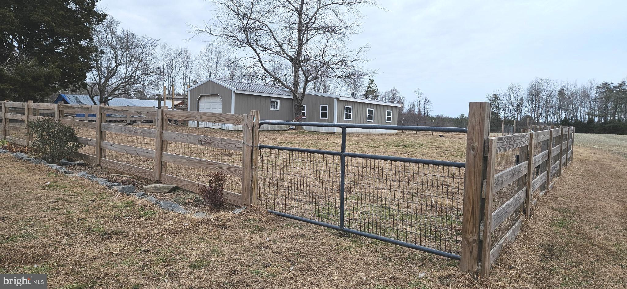 2033 Courthouse Road Heathsville, VA 22473 - Photo 5 of 50 a view of a wooden house with a large trees