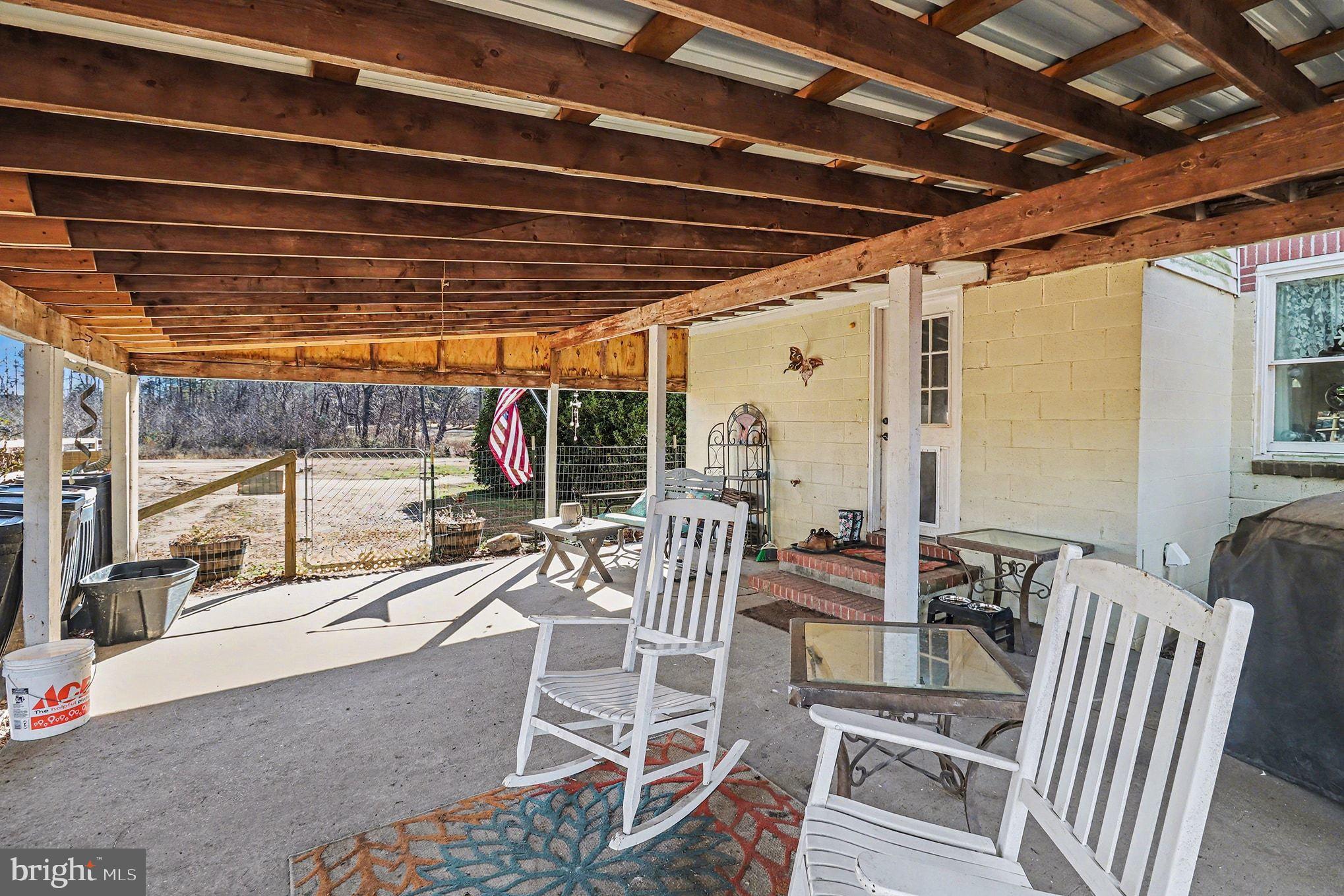 2033 Courthouse Road Heathsville, VA 22473 - Photo 6 of 50 a view of a patio with a table and chairs and potted plants