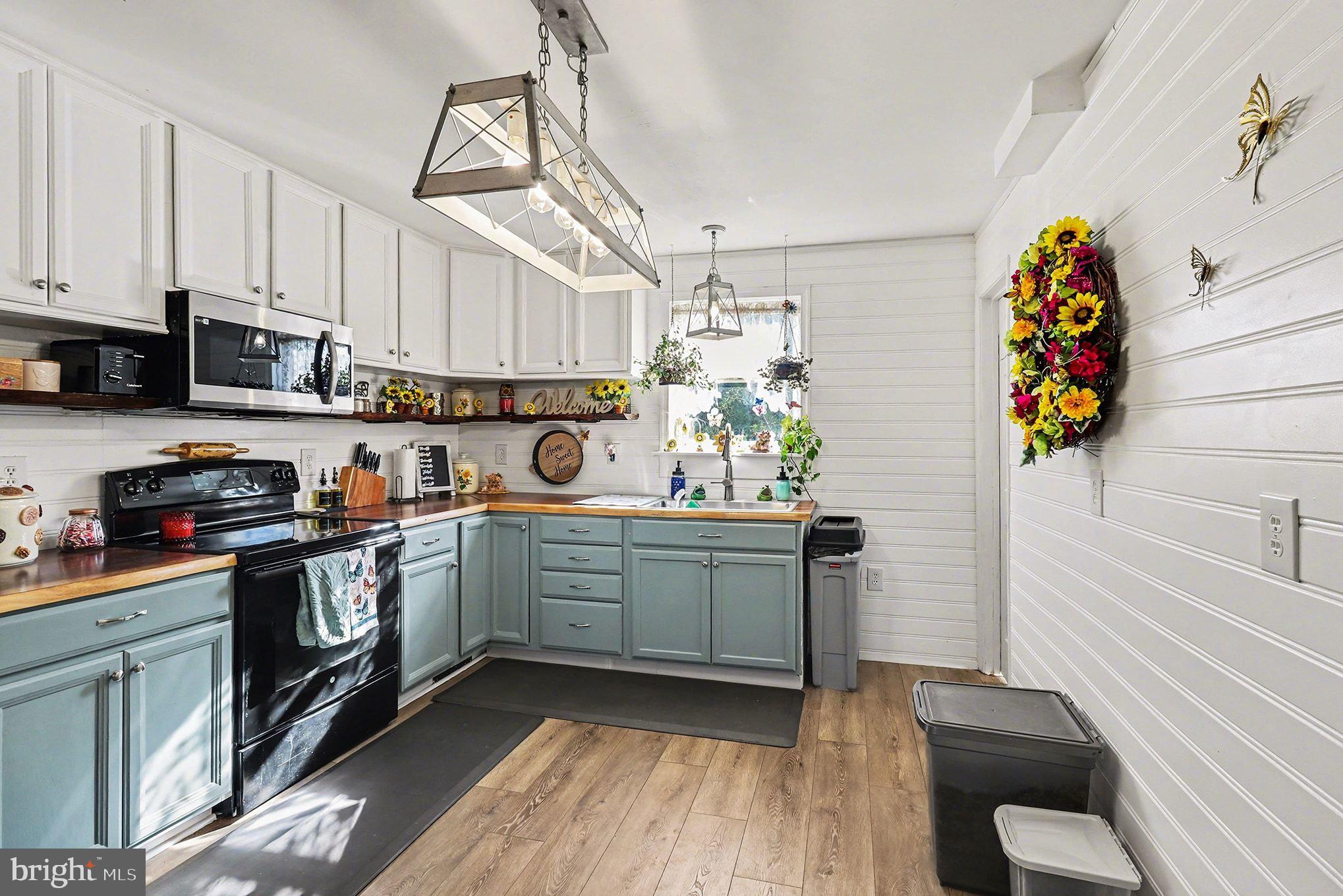 2033 Courthouse Road Heathsville, VA 22473 - Photo 10 of 50 a kitchen with stainless steel appliances granite countertop a sink and cabinets