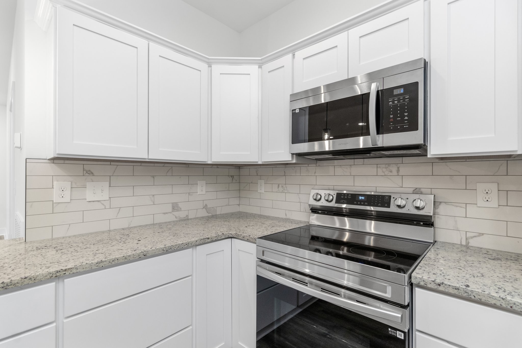 297 Wayne Hall Road Clarksville, TN 37040 - Photo 10 of 35 a kitchen with stainless steel appliances granite countertop white cabinets and a stove top oven