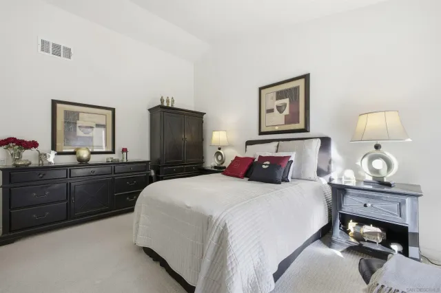 a bedroom with a bed and a dresser