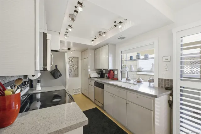 a kitchen with a sink stove and cabinets