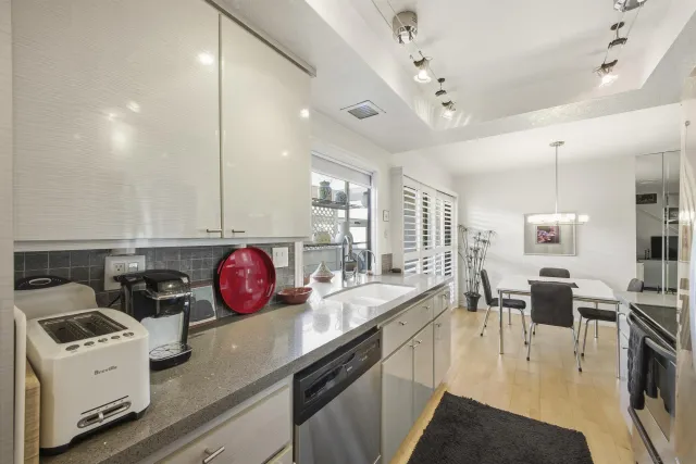 a kitchen with a sink appliances and cabinets