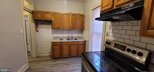 a kitchen with stainless steel appliances granite countertop a stove and a microwave