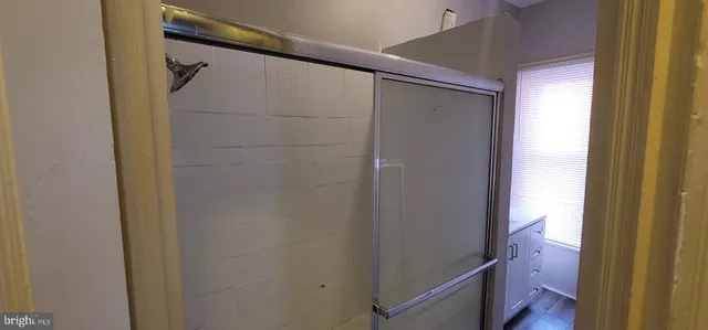 a bathroom with a shower and a mirror