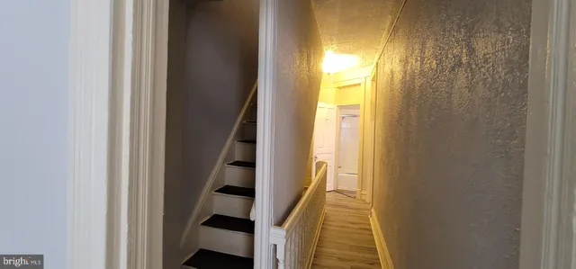 a view of entryway with wooden floor and door